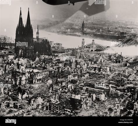 The Cologne cathedral stands tall amidst the ruins of the city after Allied bombings, 1944 ...