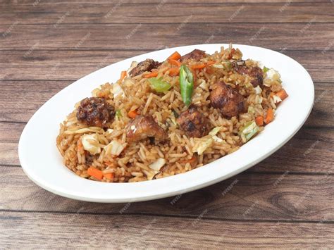 Premium Photo | Veg manchurian fried rice made of fried mixed vegetables balls along with rice ...