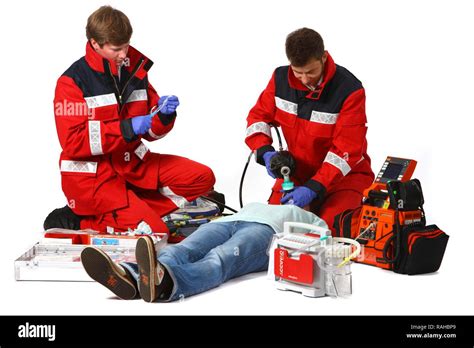 Paramedics with emergency equipment, a first aid kit with bandages, medication, a defibrillator ...