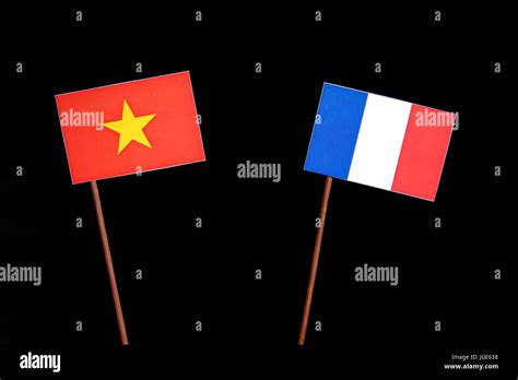 Vietnamese flag with French flag isolated on black background Stock Photo - Alamy