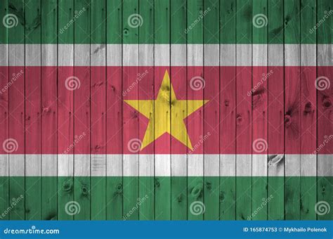 Suriname Flag Depicted in Bright Paint Colors on Old Wooden Wall. Textured Banner on Rough ...