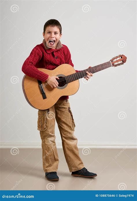 Boy Having Fun with Guitar, Making Music and Singing Stock Photo ...