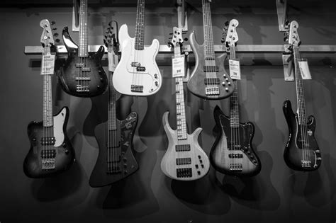8 Electric Guitars Hanged on Brown Steel Bar · Free Stock Photo