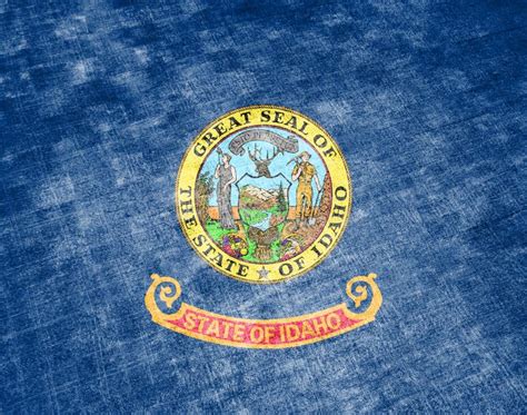 The National Flag Of The US State Idaho In Against A Gray Textile Rag On The Day Of Independence ...