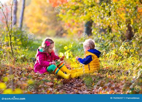 Kids Playing in Autumn Park Stock Image - Image of october, kids: 76256227