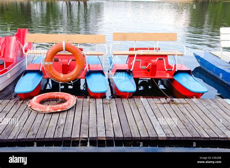 colorful pedalo on resort lake and life buoy Stock Photo - Alamy