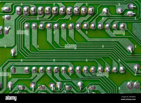 A part of a green printed circuit computer board with tracks. PCB without radio components. Old ...