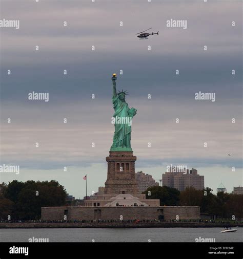 Helicopter Flying over the Statue of Liberty Stock Photo - Alamy