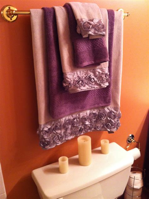 Bathroom update! Nice grey towels with decorative roses and deep purple accents. Simple way to ...