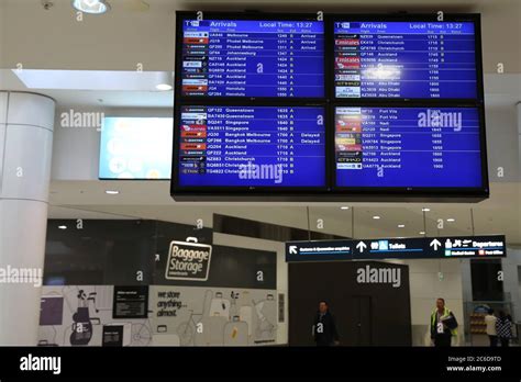 An arrivals screen at Sydney International Airport Stock Photo - Alamy