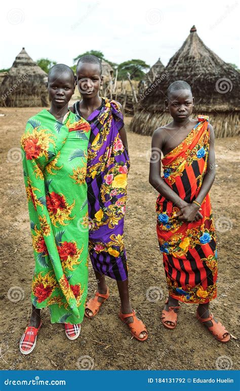 TOPOSA TRIBE, SOUTH SUDAN - MARCH 12, 2020: Teenagers Wrapped in Colorful Bright Fabric Looking ...