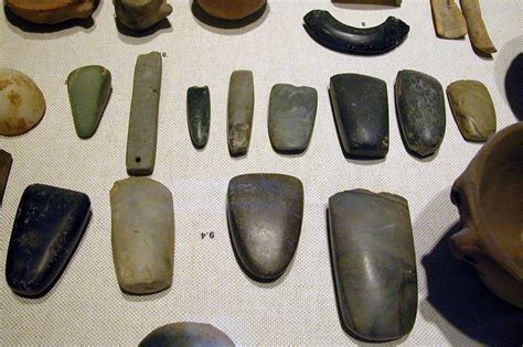 An array of Neolithic artifacts, including bracelets, axe heads ...