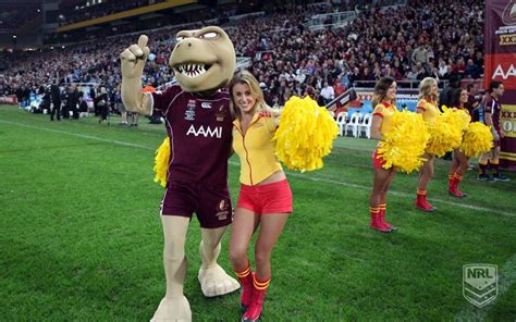 two women standing next to each other in front of a crowd at a soccer game