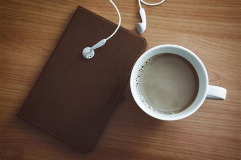 White Mug Beside Wallet and Earbuds · Free Stock Photo