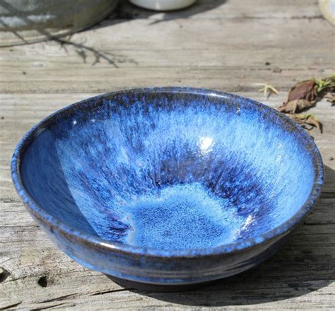 a blue bowl sitting on top of a wooden table