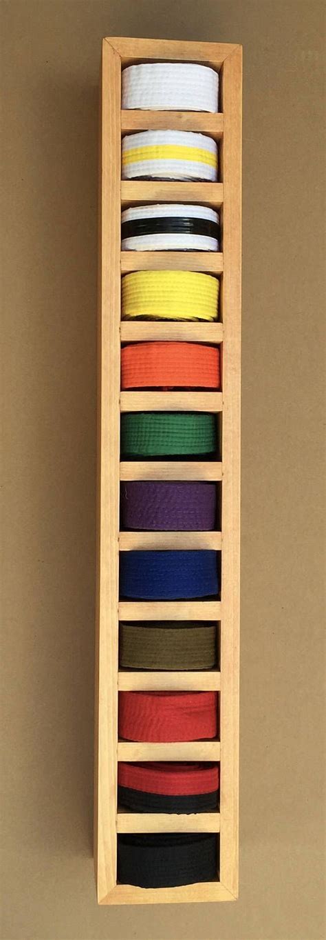 Display martial arts belts artfully with this solid wood display. It is ...