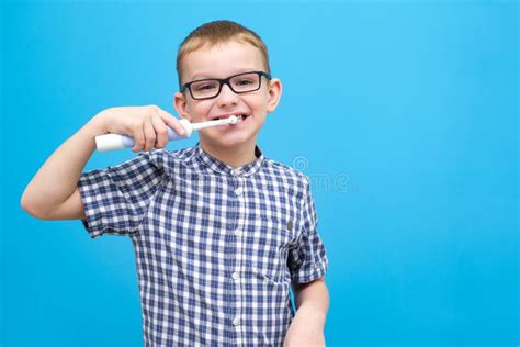 The Boy is Brushing His Teeth. a Small Child with a Toothbrush on a ...