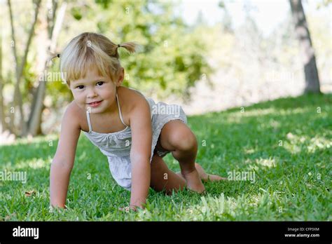 Little girl playing on grass Stock Photo - Alamy