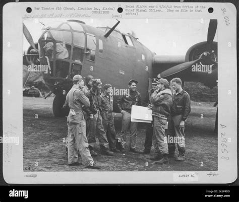 Capt. Ira Wintermuthe, holding map, gives his Consolidated B-24 crew a last minute talk before ...