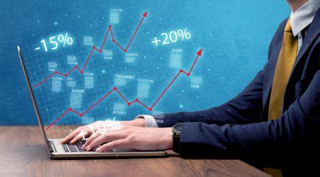 An elegant businessman working on graph statistics calculation using a laptop with clear blue ...