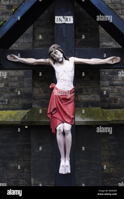 "Jesus on the Cross" statue on a wooden cross Stock Photo - Alamy