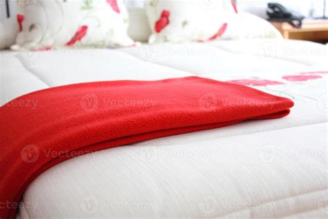 Bed with red blanket 1252472 Stock Photo at Vecteezy