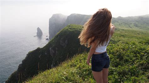 A girl standing on the edge of a cliff