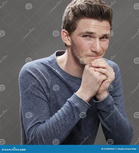 Portrait Of A Smiling Seductive Young Male Student Stock Photo - Image of indoor, hand: 67004932