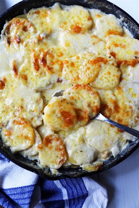 Cheesy Potatoes Au Gratin. Homemade cheesy scalloped potatoes with a rich cream sauce and melted ...