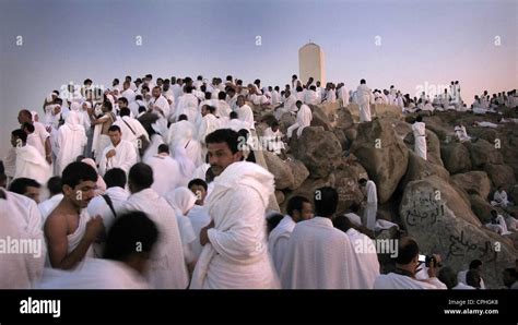 Muslim pilgrims praying at Mount Arafat, Jabal al-Ramah at sunrise ...