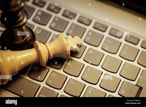 Chess kings on laptop keyboard - digital strategy Stock Photo - Alamy