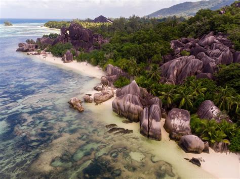 Aerial photography of multicolored granite rocks on Anse Source d ...