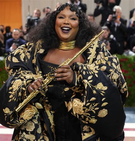 Lizzo Plays Gold John Lunn Flute on Met Red Carpet