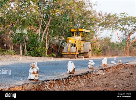 Rural indian road construction with steamroller in the background. Andhra Pradesh, India Stock ...