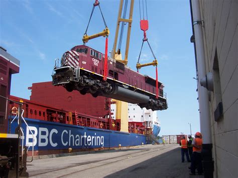 Longshoremen loading a locomotive onto a ship in the Port of Ogdensburg