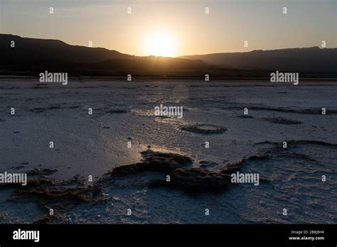 Africa, Djibouti, Lake Assal. Sunset on salt lake with mountains in the ...