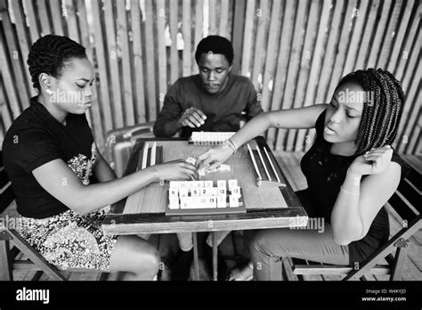 Group of three african american friends play table games Stock Photo - Alamy