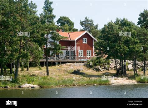 red swedish house on lake water falun paint rural countryside traditional wood wooden houses ...