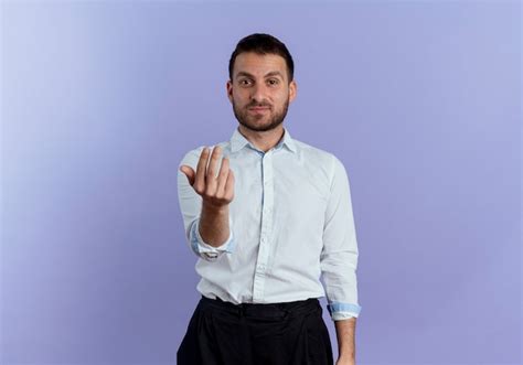 Free Photo | Confident handsome man gestures come here hand sign isolated on purple wall