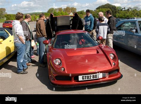 Noble enthusiasts check out the engine on a Noble M12 at the Goodwood ...