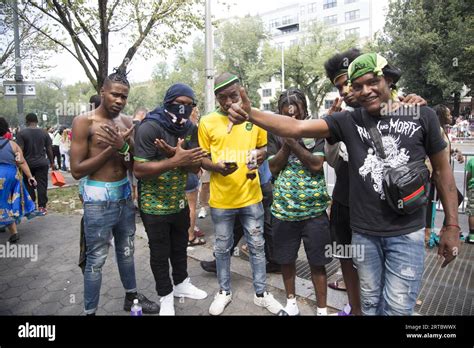 Crew of young men cruzing about at the parade. Spectators along Eastern ...