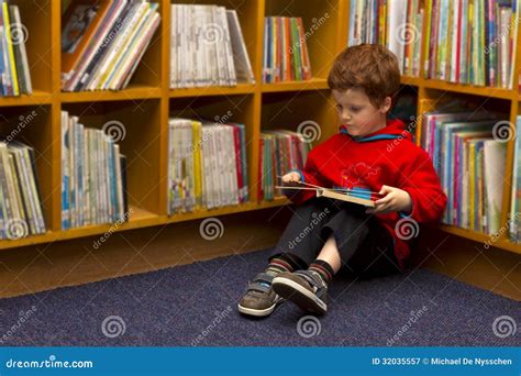 Boy Reading Learning In A Library Stock Image - Image of bookshelf, child: 32035557