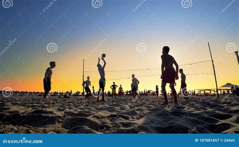 Beach volleyball at sunset editorial photography. Image of orange ...