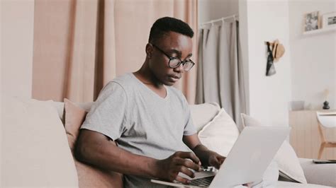 Man Reading a Book while Sitting on a Sofa · Free Stock Video