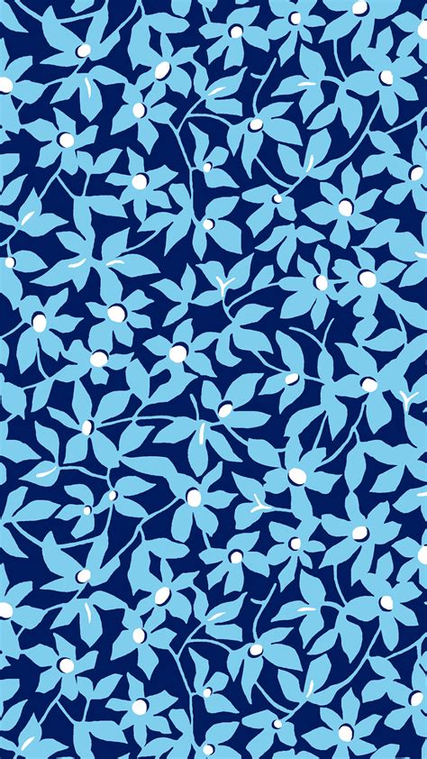 a blue and white floral pattern on a dark background with small dots in the center