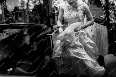 Premium Photo | Stylish bride in vintage white wedding dress getting into black limousine with ...