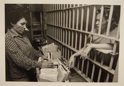 [Female Travis County Jail worker offering books to a female inmate] - Side 1 of 1 - The Portal ...