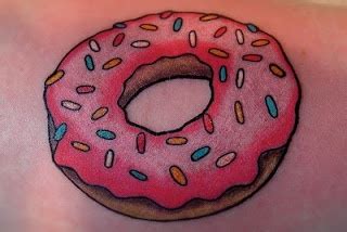 a pink donut with sprinkles on it's side tattoo design