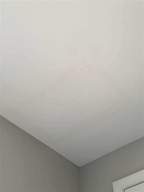 Water damage or bad patch job on the ceiling directly under the shower stall of master bath ...