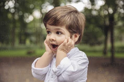 Toddler making surprised face in park stock photo